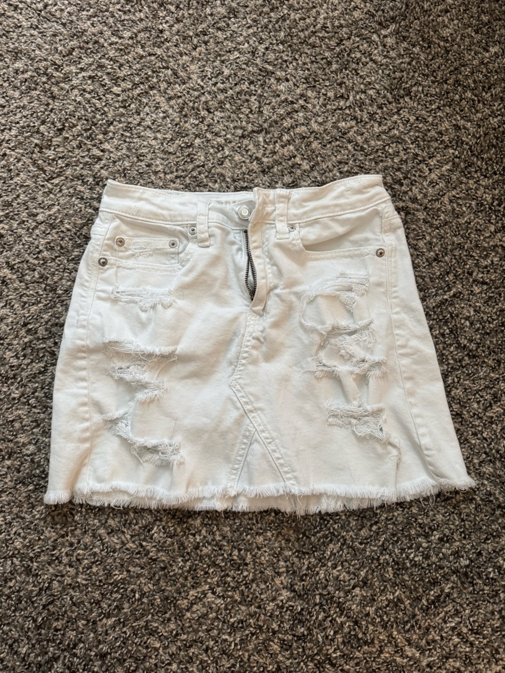 American Eagle white distressed denim mini skirt in a size US 0